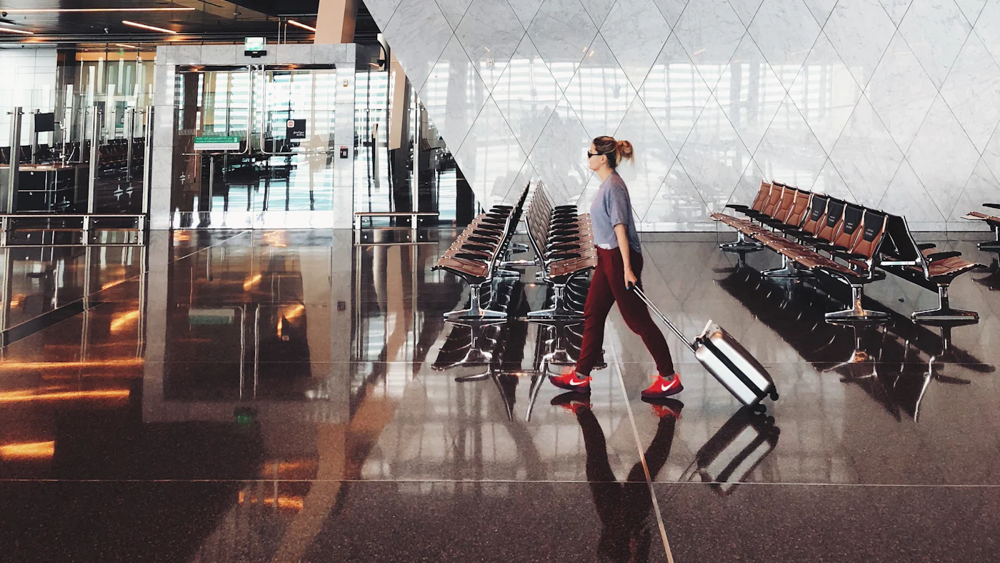 A traveller walking through an airport terminal