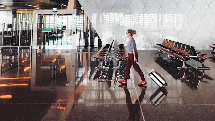 A traveller walking through an airport terminal